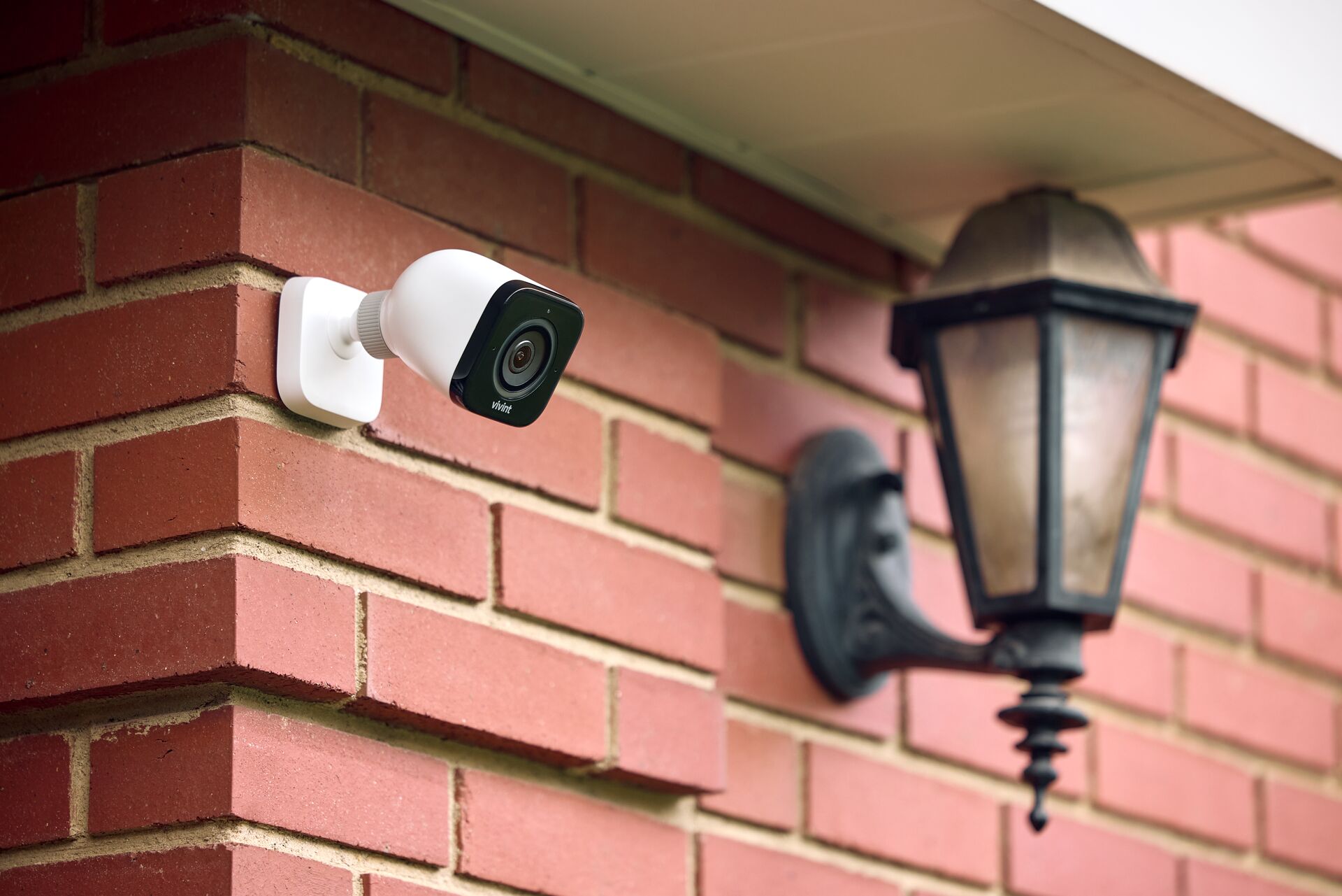 Brick wall exterior mounted professional security camera with high impact vandal resistant housing